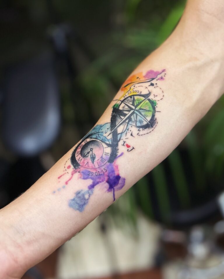 Watercolor compass and clock tattoo on inner forearm – color tattoo by DR G