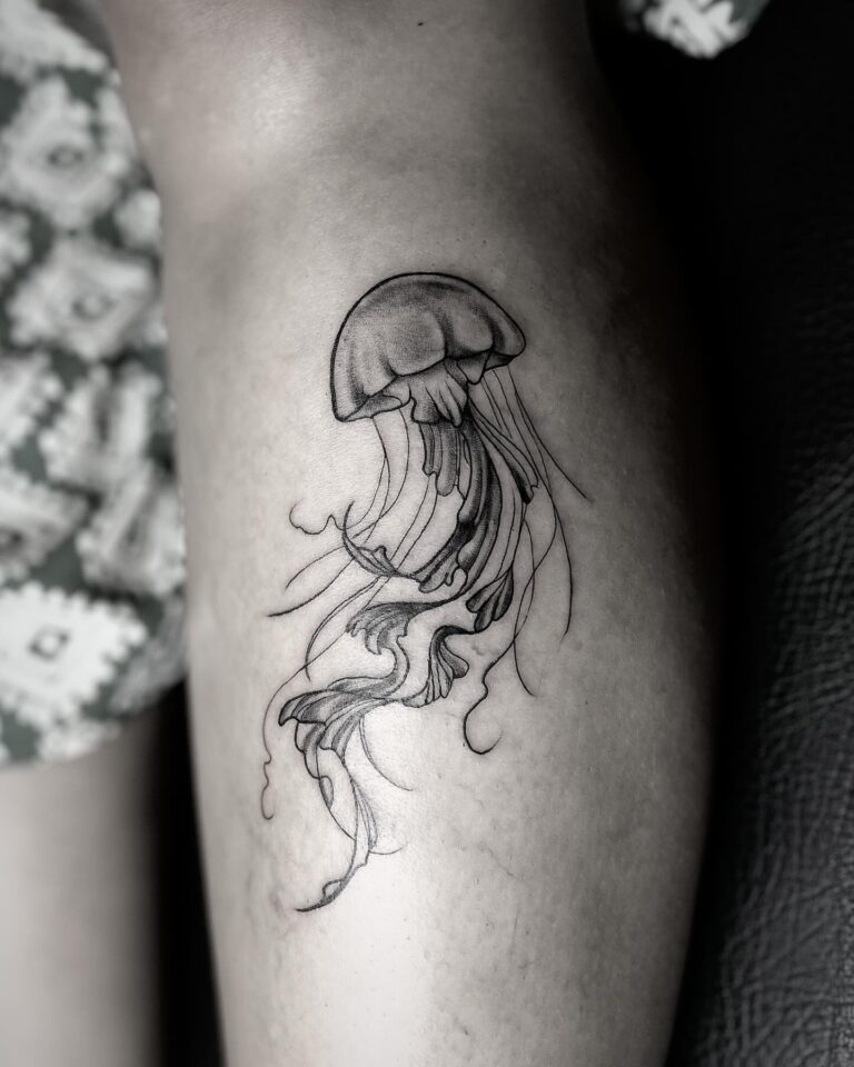 Fine line jellyfish tattoo on arm – minimal black ink, DR G Tattoo Hurghada