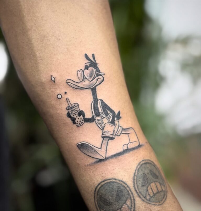 Fine line cartoon duck tattoo on forearm – black and grey, DR G Tattoo Hurghada