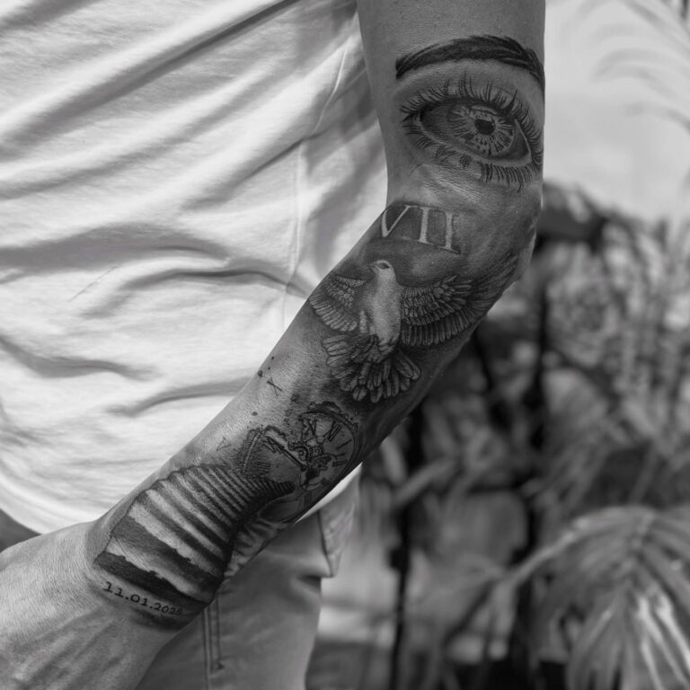 Black and grey forearm sleeve with dove, eye and Roman numerals – Hurghada