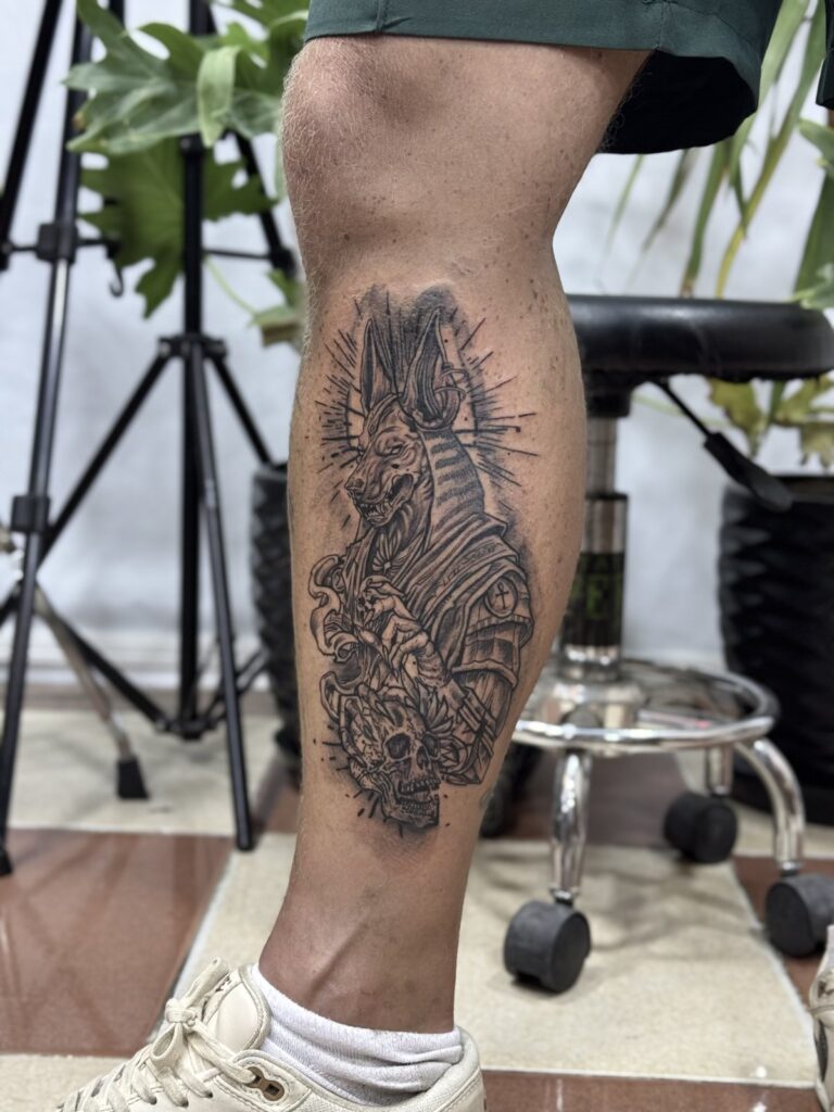 Egyptian pharaoh and hieroglyphs calf tattoo – black and grey, Hurghada