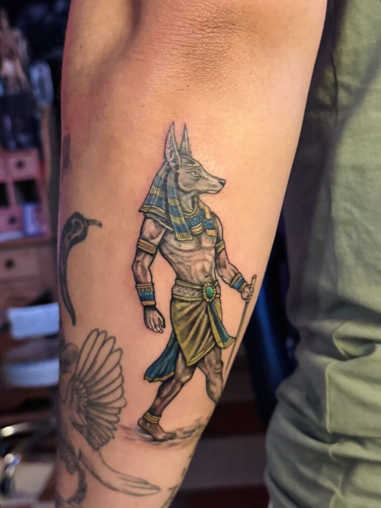 Color Anubis figure tattoo on forearm – Egyptian color tattoo Hurghada