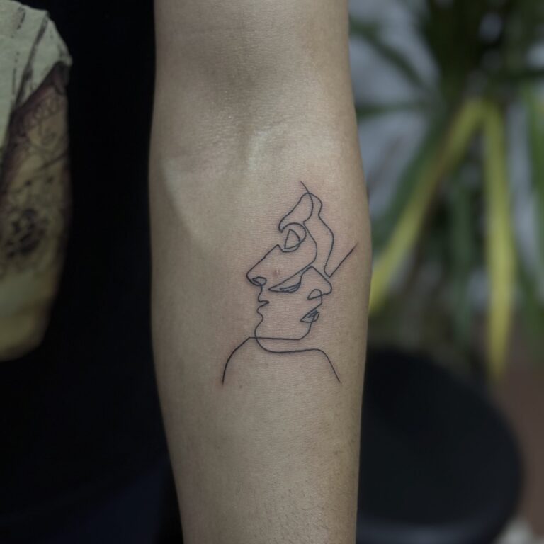 One-line face profile tattoo on forearm – minimal fine line tattoo