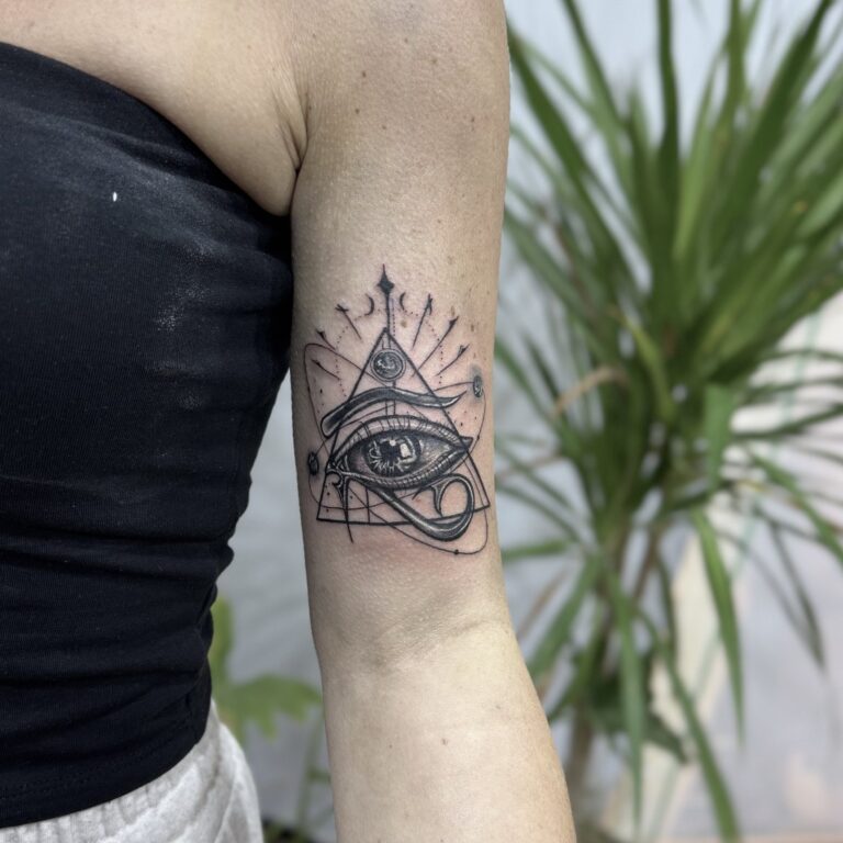 All-seeing eye in triangle forearm tattoo – black and grey linework