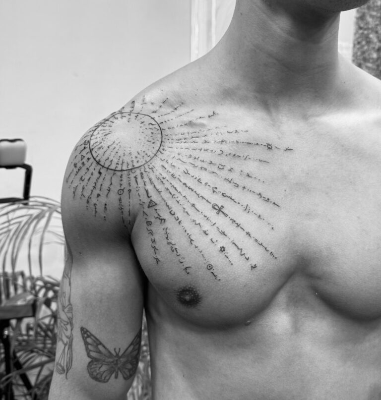 Sun mandala fine line shoulder and chest tattoo with small script